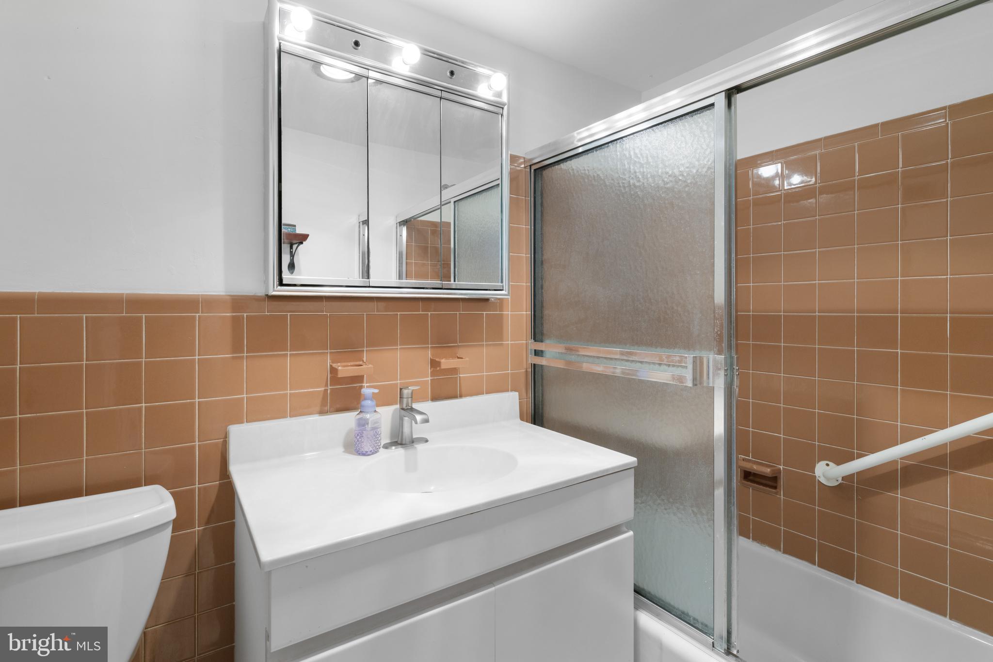 7900 Old York Road, Unit 303B Elkins Park, PA 19027 - Photo 14 of 27 a bathroom with a sink a toilet and shower