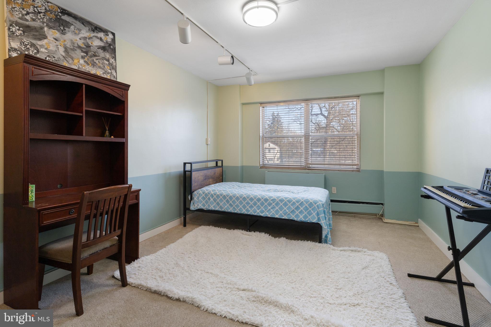 7900 Old York Road, Unit 303B Elkins Park, PA 19027 - Photo 15 of 27 a bedroom with a bed chair and a window
