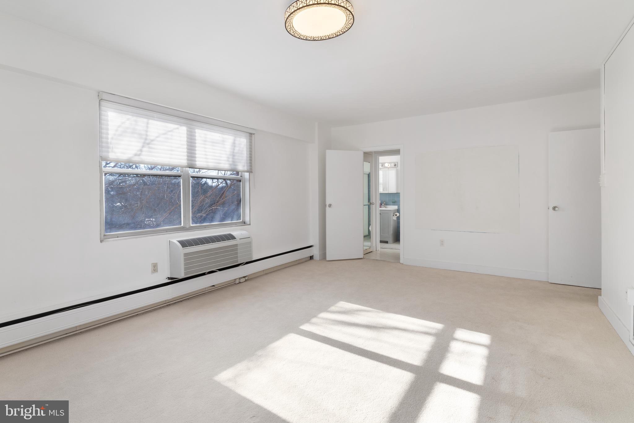 7900 Old York Road, Unit 303B Elkins Park, PA 19027 - Photo 18 of 27 an empty room with windows