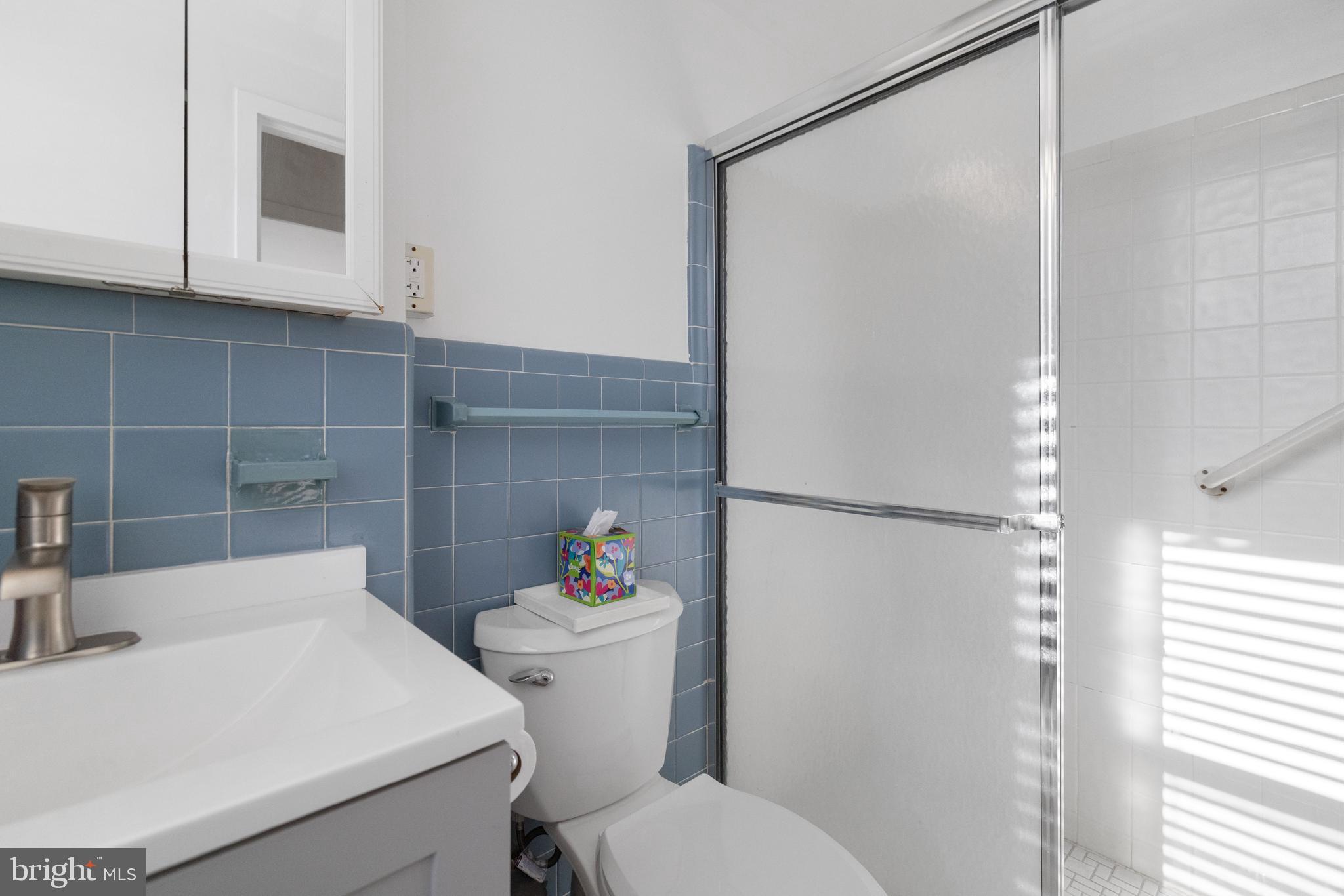 7900 Old York Road, Unit 303B Elkins Park, PA 19027 - Photo 20 of 27 a white toilet sitting next to a bathroom sink