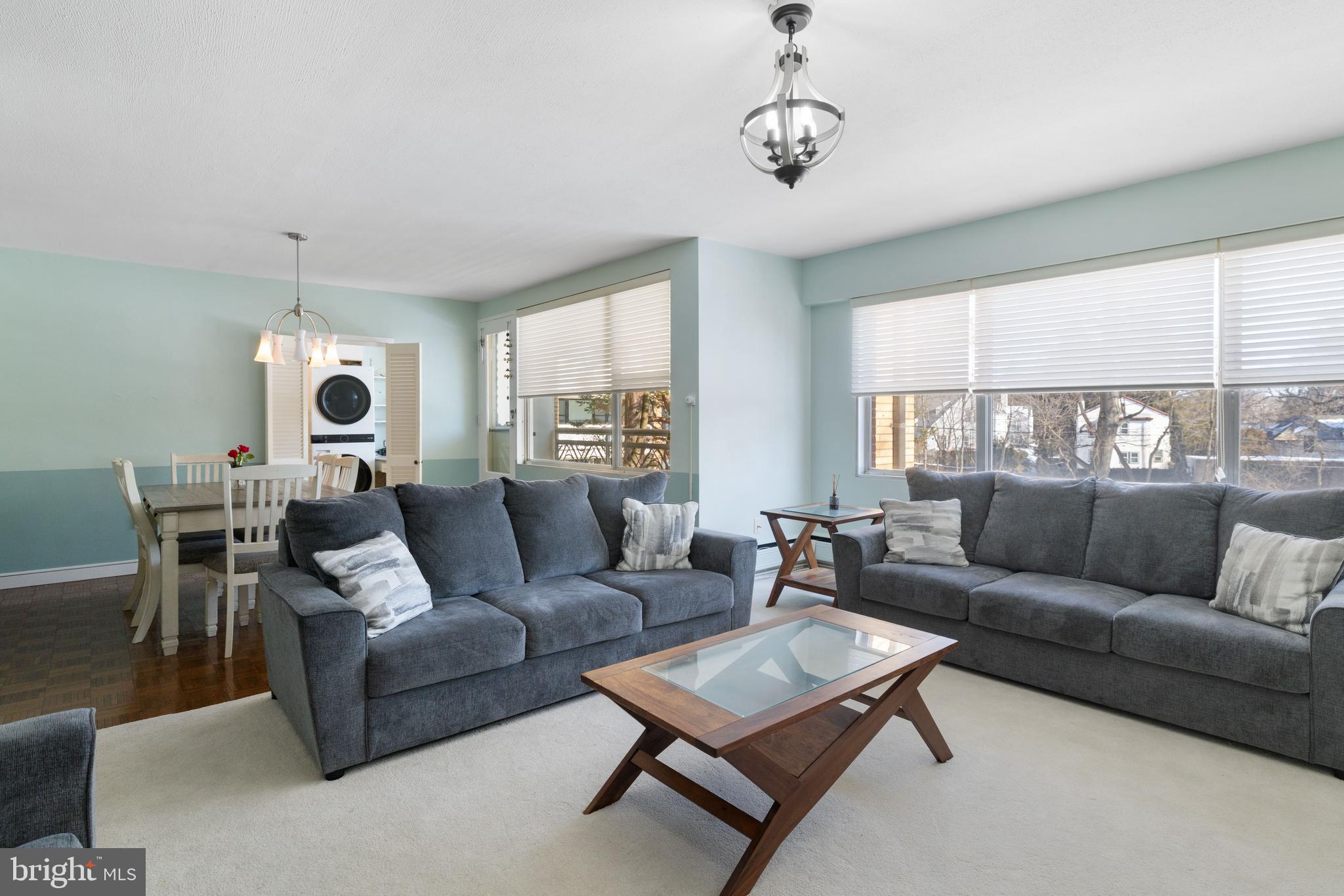 7900 Old York Road, Unit 303B Elkins Park, PA 19027 - Photo 4 of 27 a living room with furniture and a chandelier