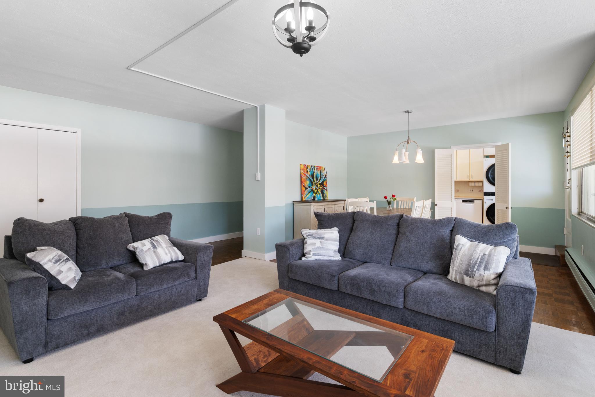 7900 Old York Road, Unit 303B Elkins Park, PA 19027 - Photo 5 of 27 a living room with furniture and a chandelier