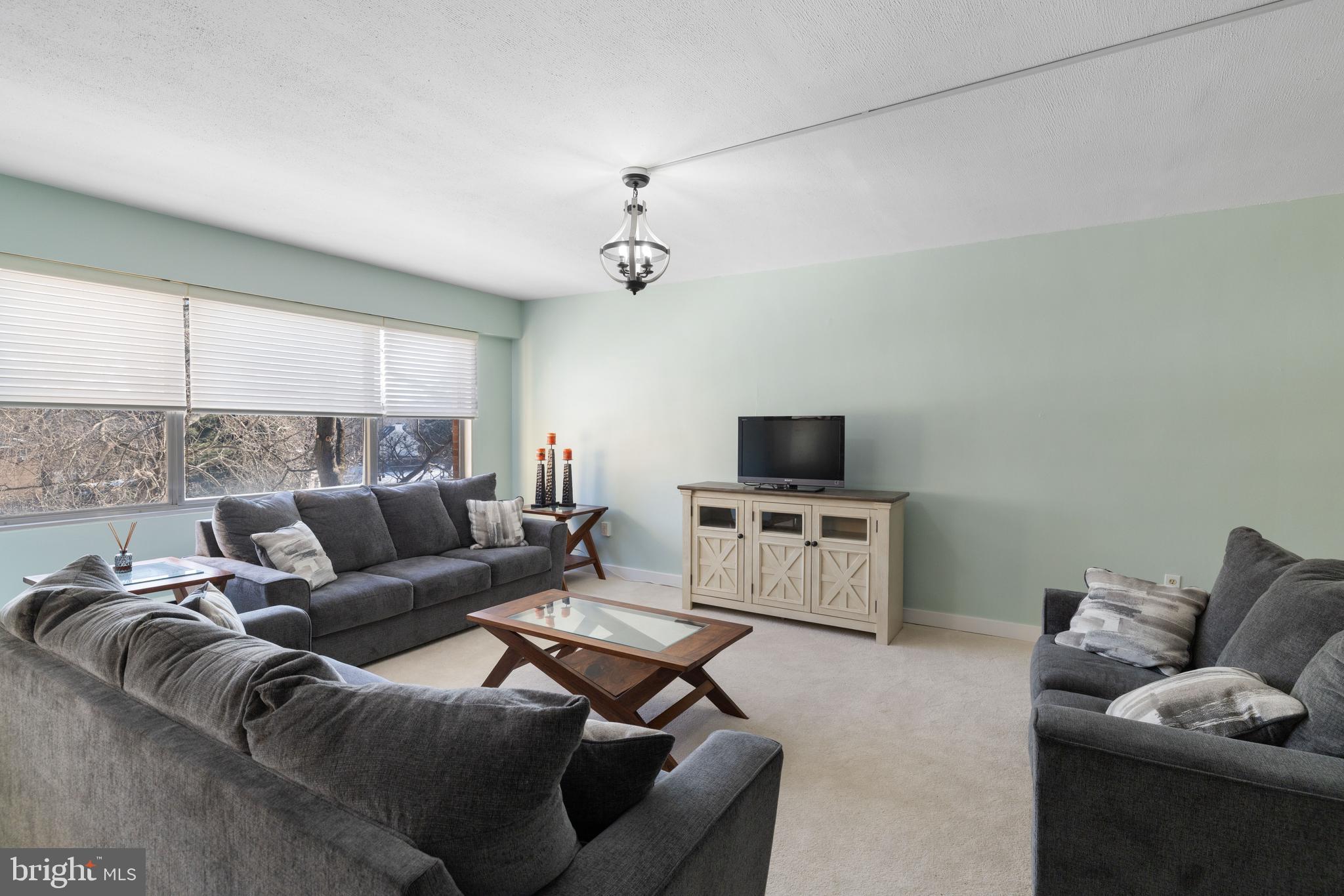 7900 Old York Road, Unit 303B Elkins Park, PA 19027 - Photo 6 of 27 a living room with furniture and a flat screen tv