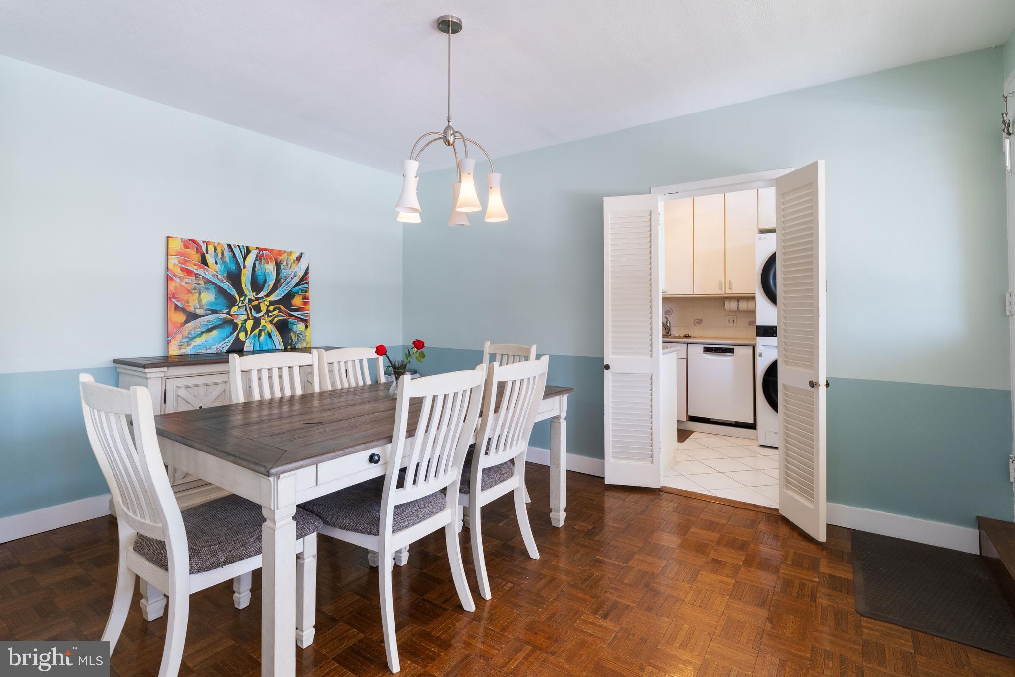 7900 Old York Road, Unit 303B Elkins Park, PA 19027 - Photo 8 of 27 a view of a dining room with furniture wooden floor and a chandelier