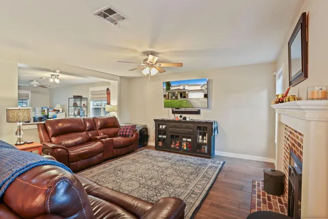 a living room with furniture a fireplace and a flat screen tv