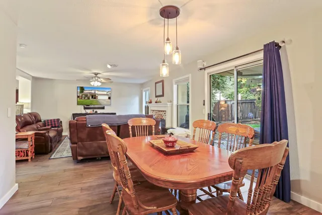 a view of a dining room with furniture large windows and wooden floor