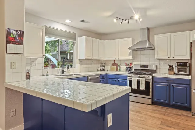 a kitchen with a sink a window and cabinets