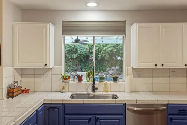 a kitchen with stainless steel appliances granite countertop wooden cabinets stove top oven and sink