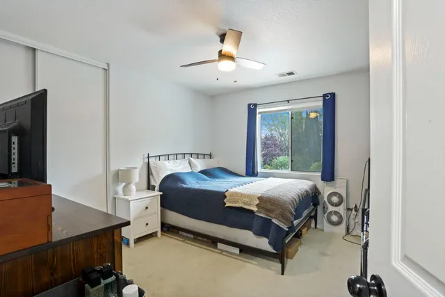 a bedroom with a bed and a tv