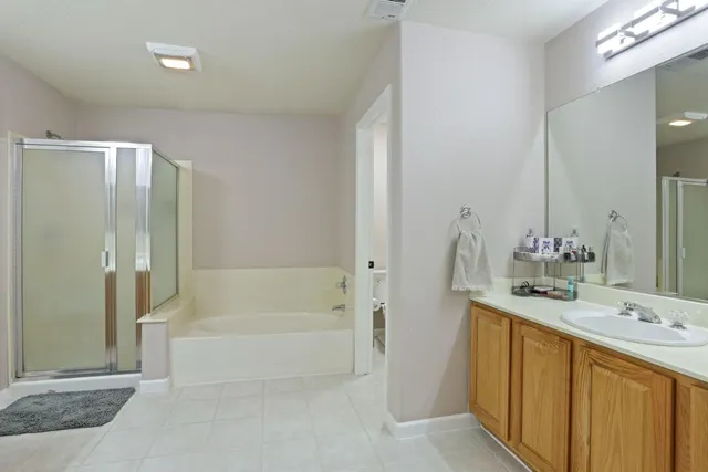 a bathroom with a bathtub shower sink and mirror
