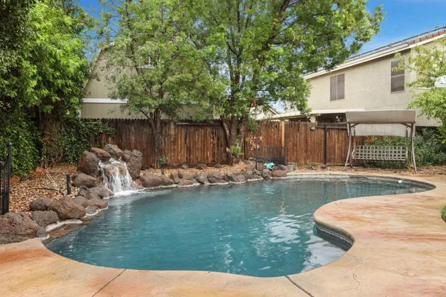 a view of a backyard with swimming pool