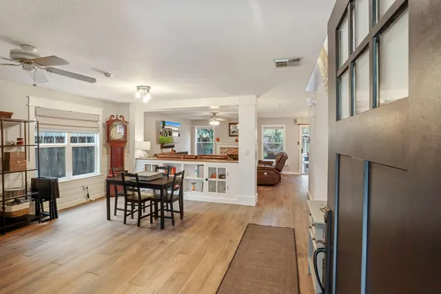 a view of a dining room with furniture and wooden floor