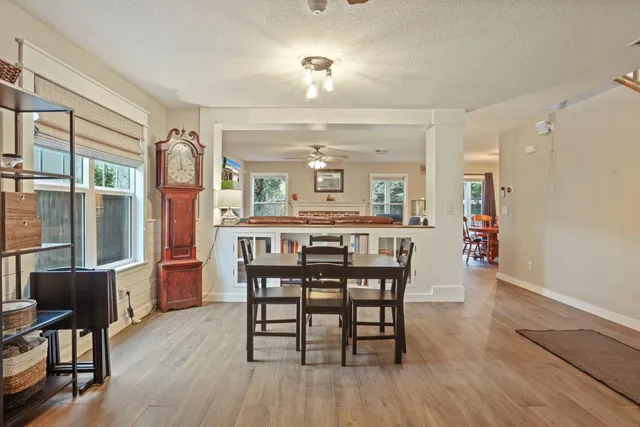 a view of a dining room with furniture and wooden floor