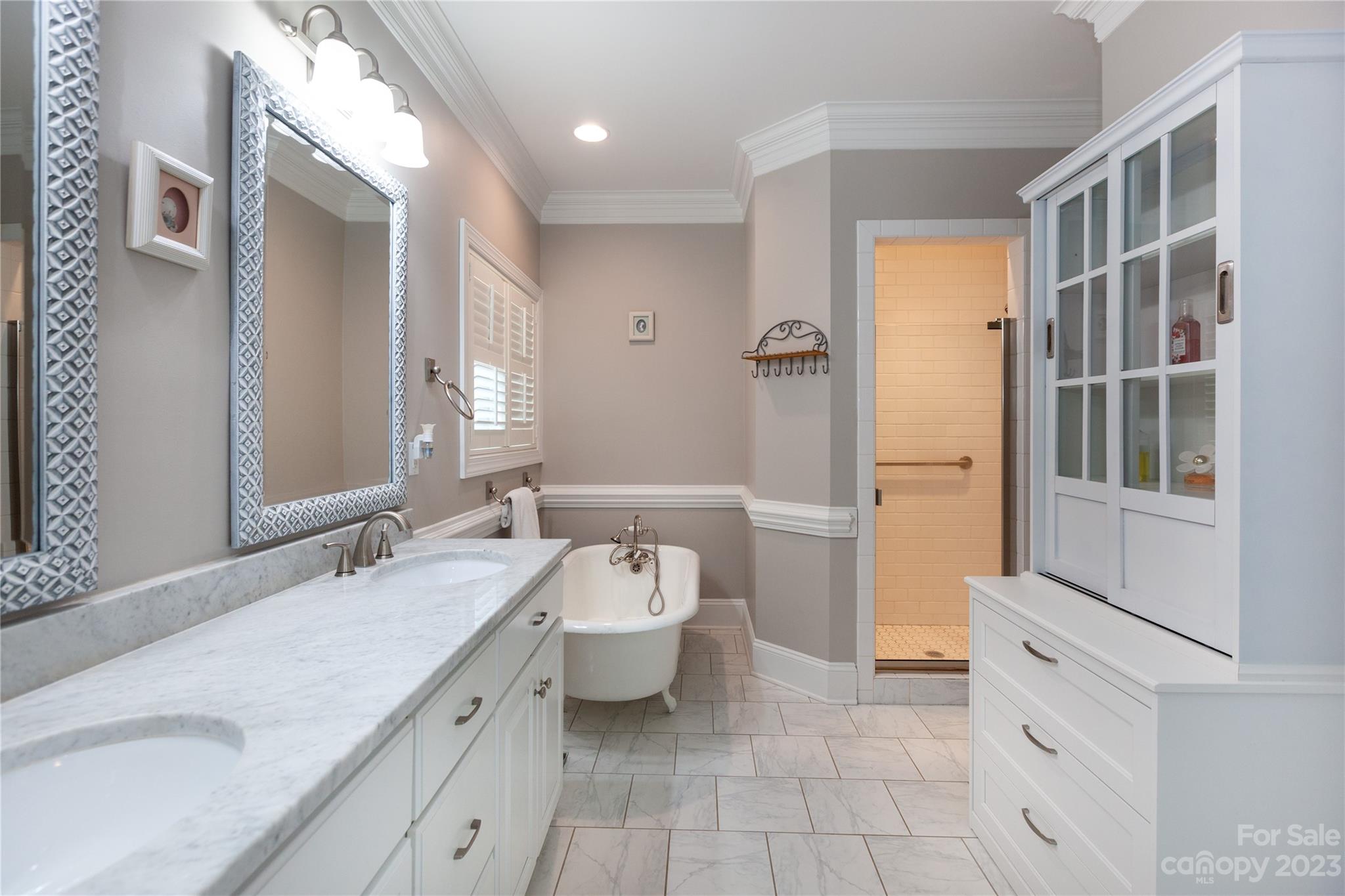 4058 Halyard Drive Denver, NC 28037 - Photo 25 of 46 a bathroom with a double vanity sink a mirror and a bathtub