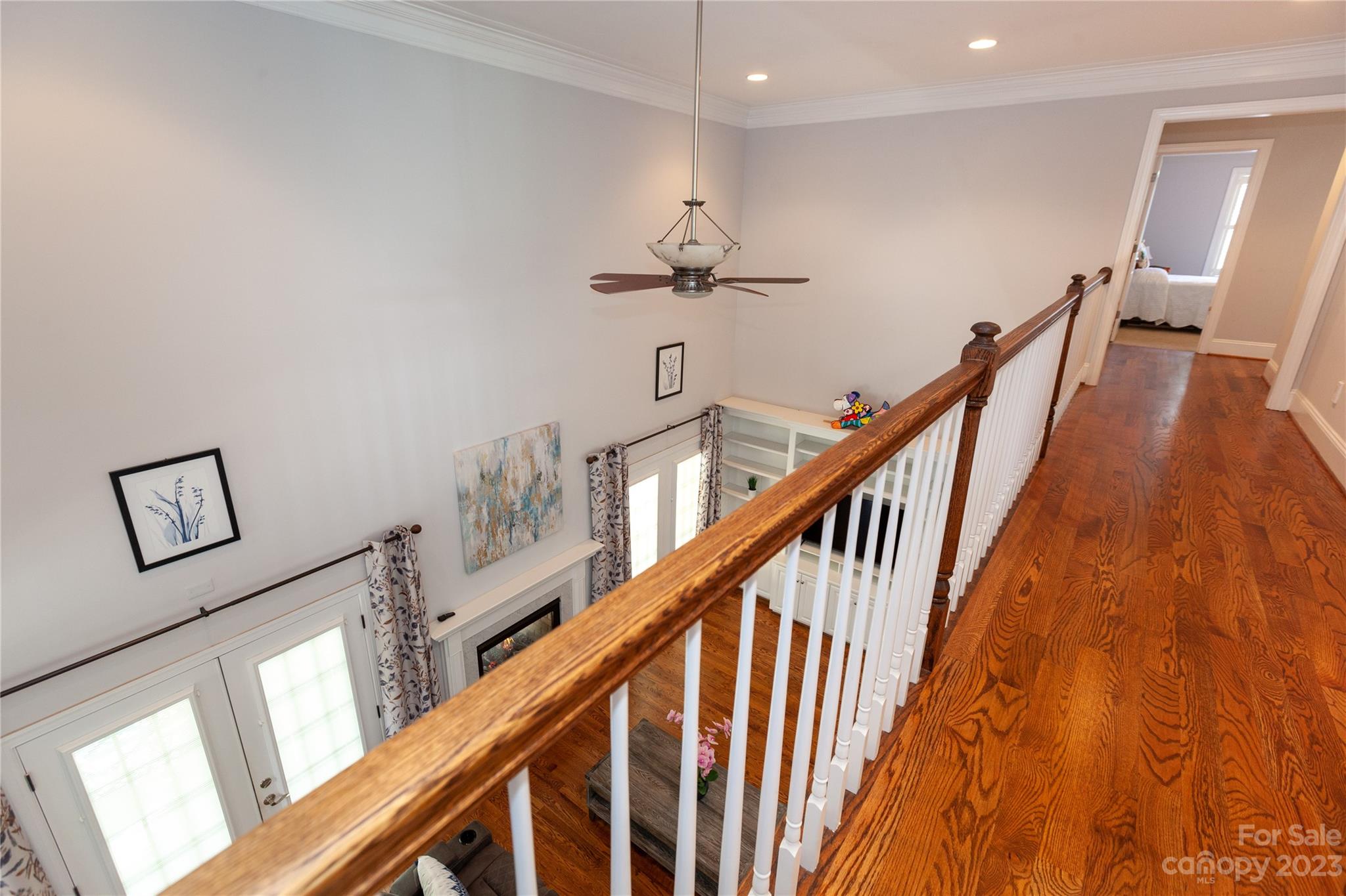 4058 Halyard Drive Denver, NC 28037 - Photo 35 of 46 a view of staircase with lots of frames on wall and wooden floor