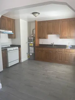 a large kitchen with cabinets and a stove