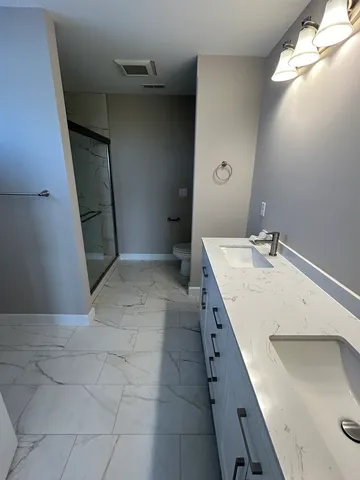 a view of a bathroom with sink and mirror