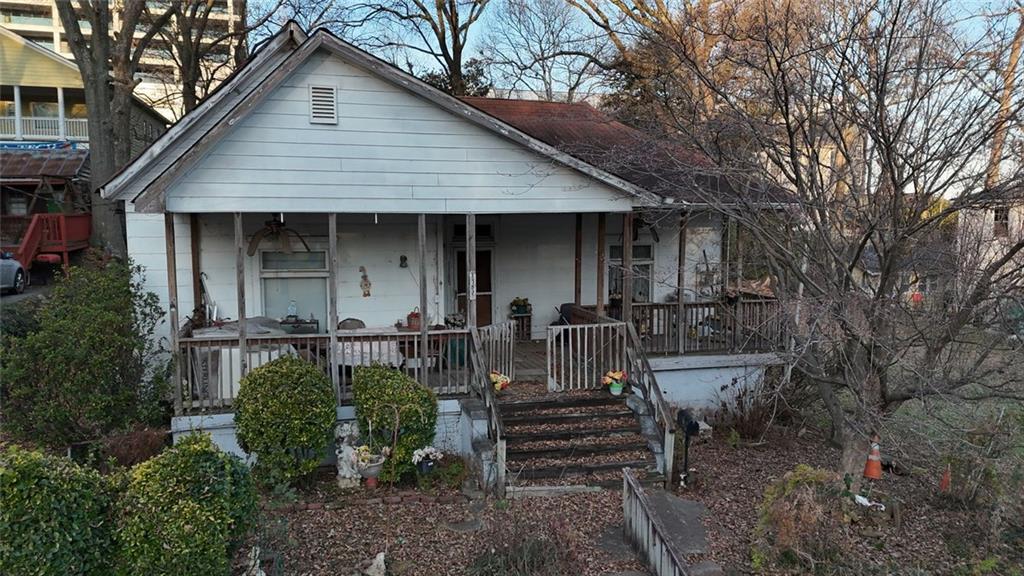 1052 Curran Street Northwest Atlanta, GA 30318 - Photo 1 of 13 a front view of a house with table and chairs