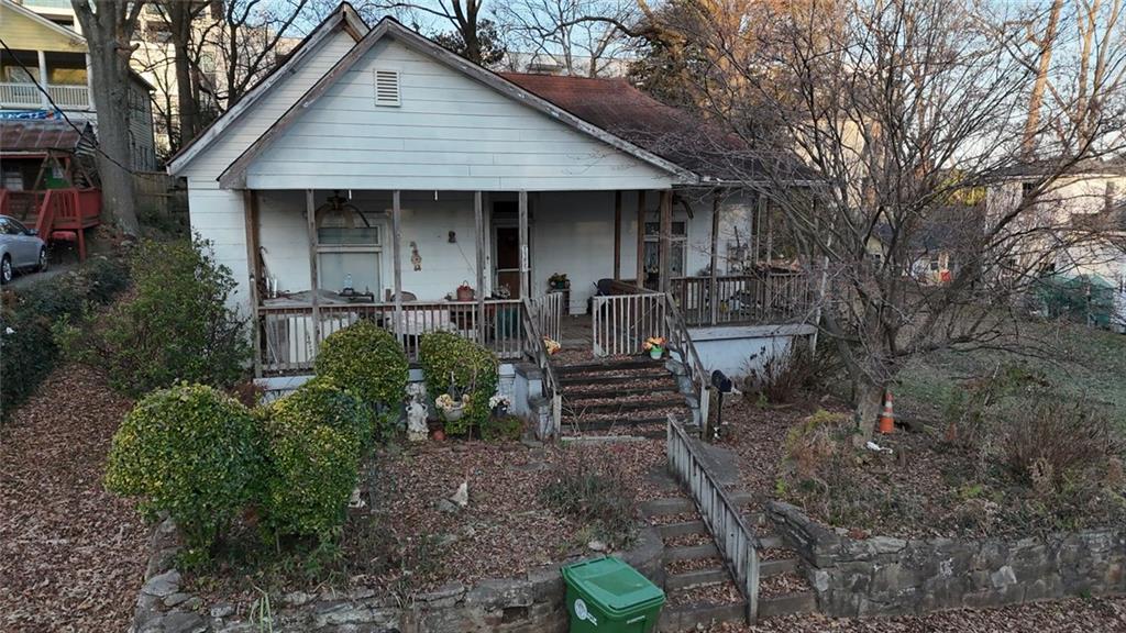 1052 Curran Street Northwest Atlanta, GA 30318 - Photo 2 of 13 a front view of a house with garden