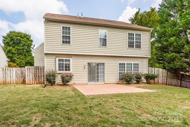 a front view of house with a garden