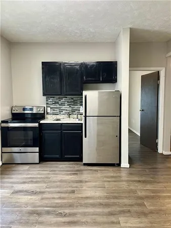 a kitchen with a stove and a refrigerator