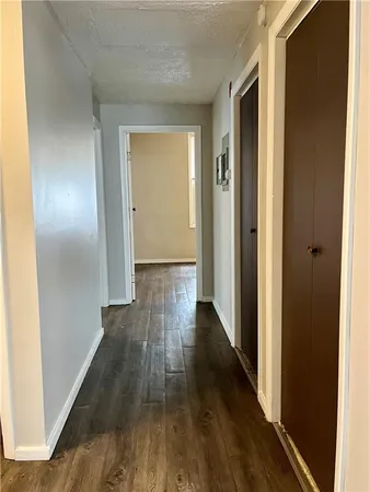a view of a hallway with wooden floor