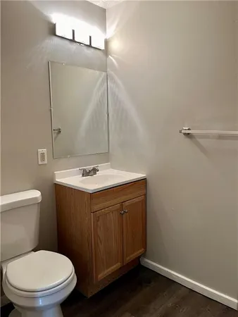 a bathroom with a sink mirror vanity and toilet