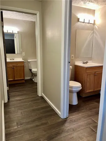 a bathroom with a sink toilet and mirror
