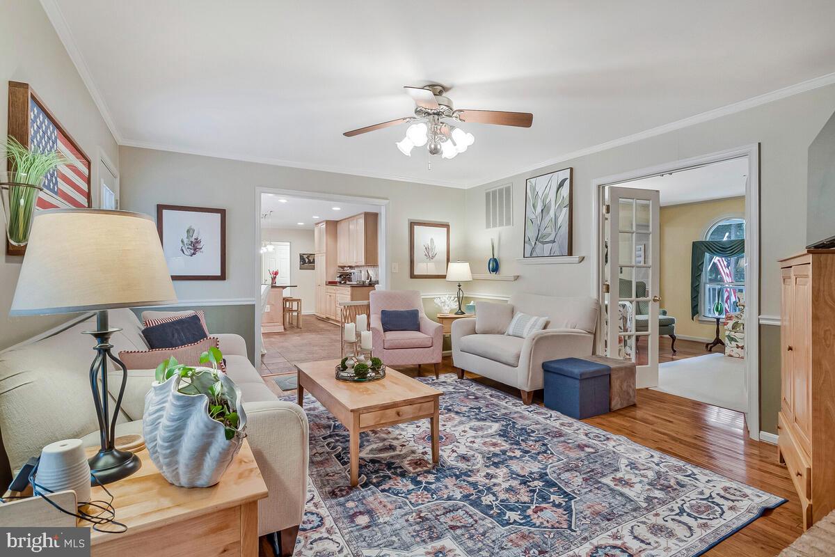 3897 Hunting Creek Road Huntingtown, MD 20639 - Photo 12 of 75 a living room with furniture a rug and a chandelier