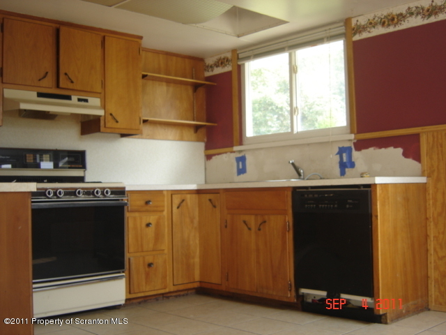 50 Dukerich Road Union Dale, PA 18470 - Photo 4 of 10 a kitchen with stainless steel appliances a stove a microwave and a refrigerator