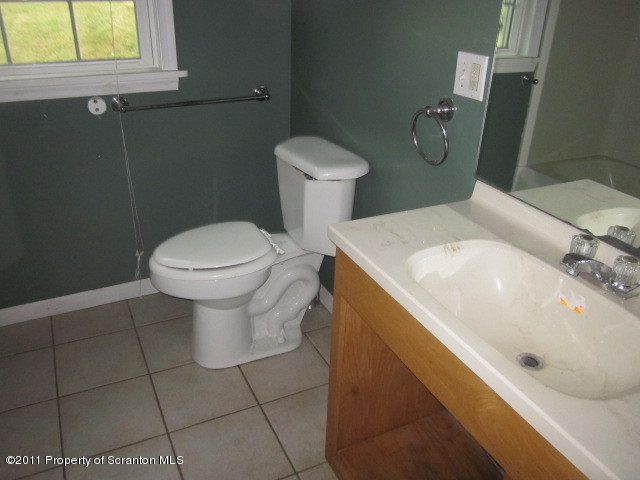 50 Dukerich Road Union Dale, PA 18470 - Photo 10 of 10 a bathroom with a sink a toilet and a mirror