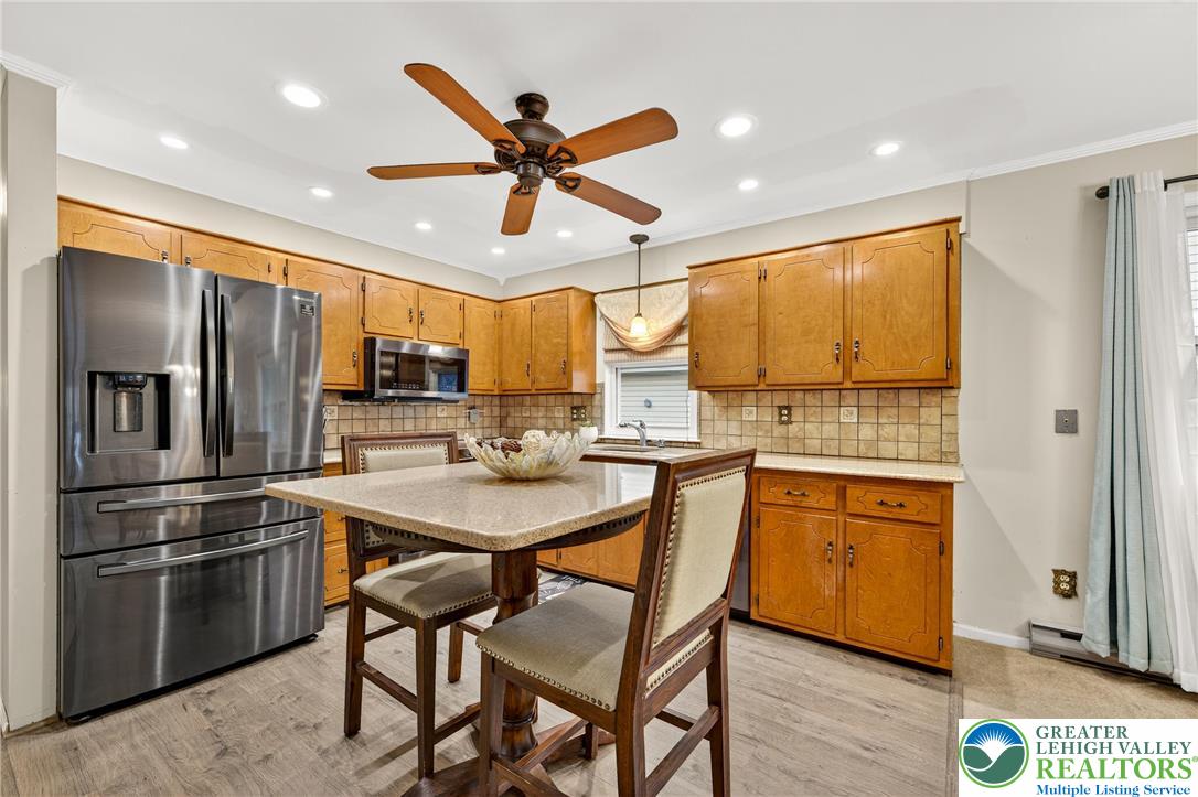 849 Weil Street Bethlehem, PA 18015 - Photo 18 of 58 a kitchen with stainless steel appliances kitchen island granite countertop a refrigerator a sink a stove and white cabinets with wooden floor