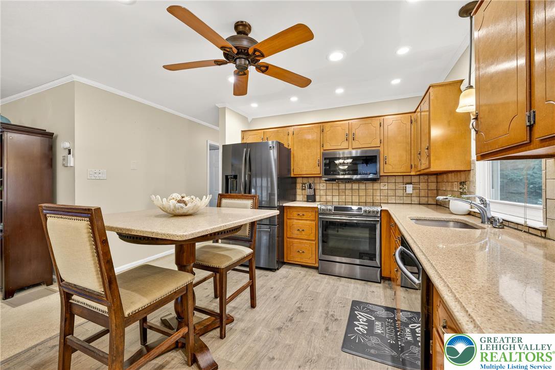 849 Weil Street Bethlehem, PA 18015 - Photo 19 of 58 a kitchen with a table chairs refrigerator and microwave