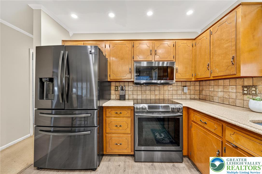 849 Weil Street Bethlehem, PA 18015 - Photo 20 of 58 a kitchen with stainless steel appliances granite countertop a refrigerator a stove a sink and a microwave
