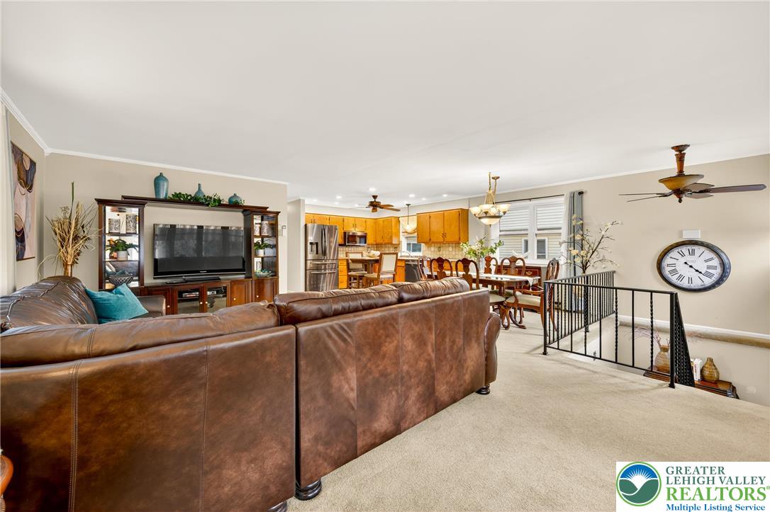 849 Weil Street Bethlehem, PA 18015 - Photo 9 of 58 a living room with furniture a clock and a flat screen tv