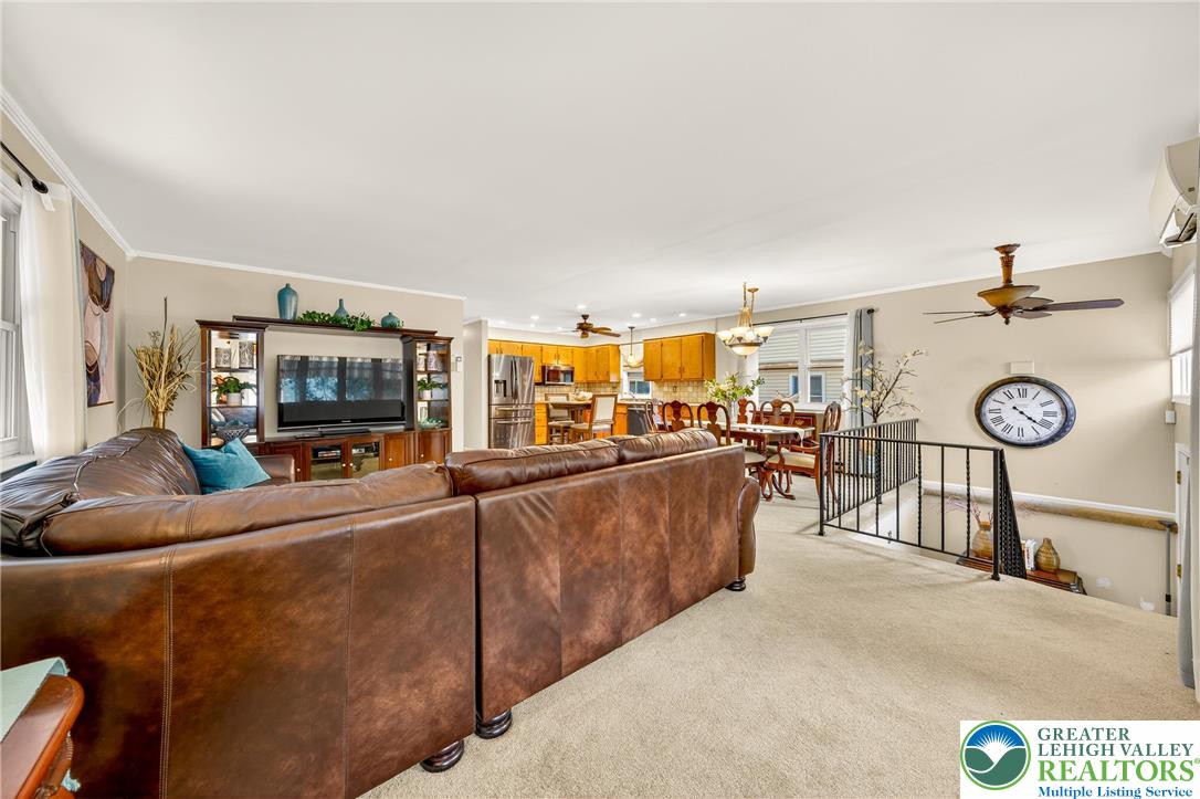 849 Weil Street Bethlehem, PA 18015 - Photo 10 of 58 a living room with furniture a clock and a flat screen tv