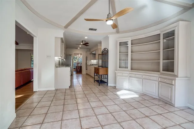 a view of empty room with wooden floor and cabinet