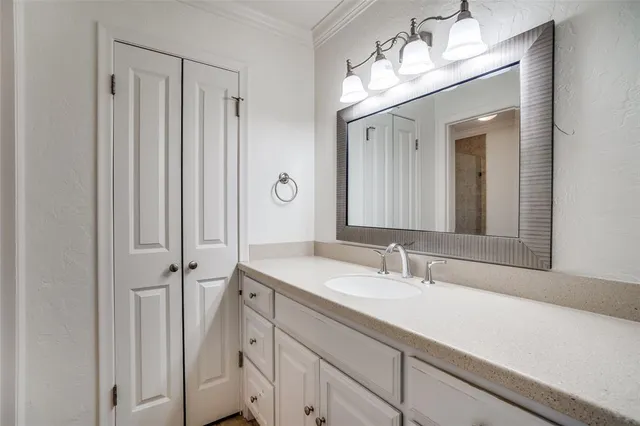 a bathroom with a sink a vanity and a mirror