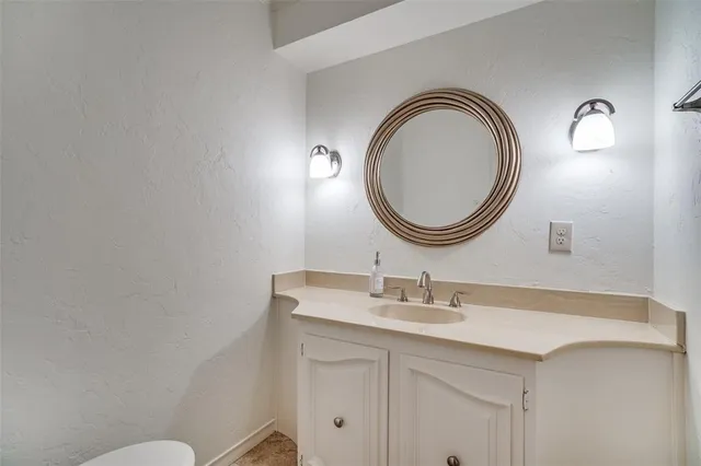 a bathroom with a toilet a sink and a mirror