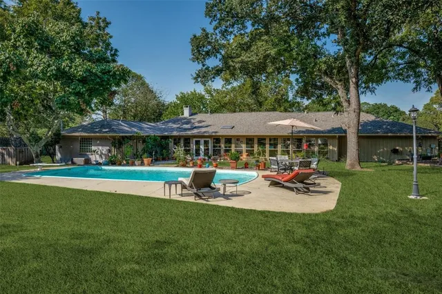 a view of a house with backyard porch and sitting area