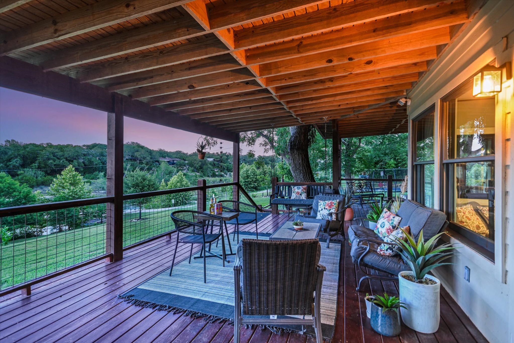 2411 Spoke Hollow Road Wimberley, TX 78676 - Photo 19 of 37 An inviting covered patio provides a serene setting with ample space for relaxation and enjoying panoramic views.