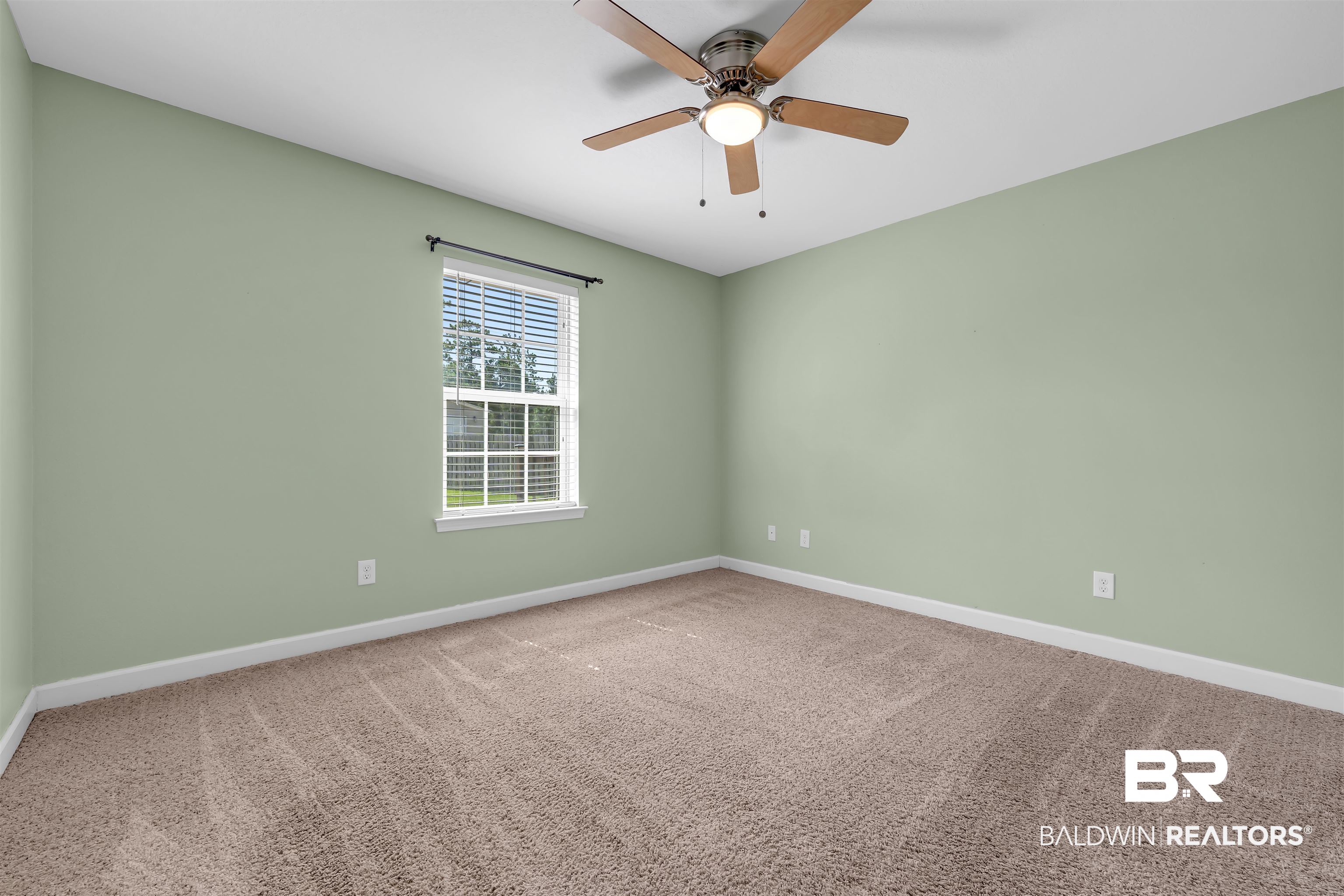 10147 Lyttleton Loop Lillian, AL 36549 - Photo 23 of 29 Room featuring neutral green walls, brown patterned carpet, and white baseboards