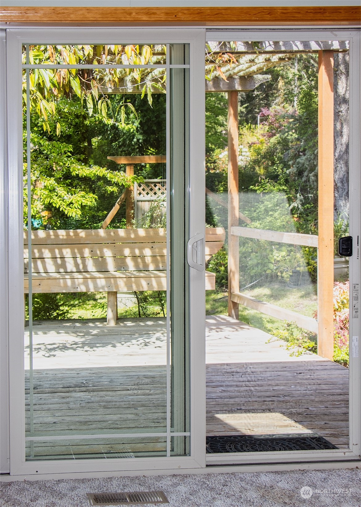 5291 Cape George Road Port Townsend, WA 98368 - Photo 12 of 25 a view of a glass door with a tree in front of it