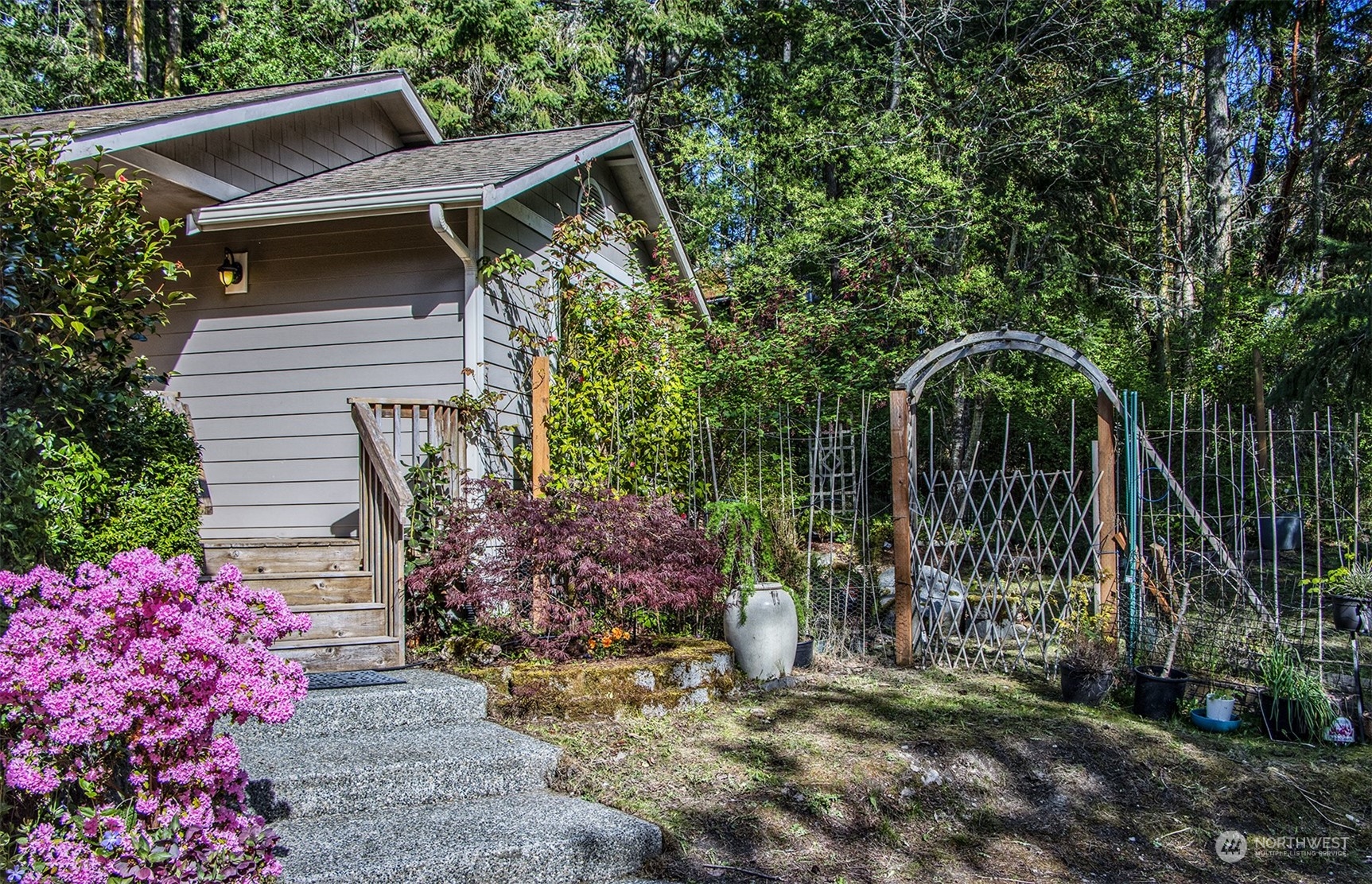 5291 Cape George Road Port Townsend, WA 98368 - Photo 4 of 25 a front view of a house with garden