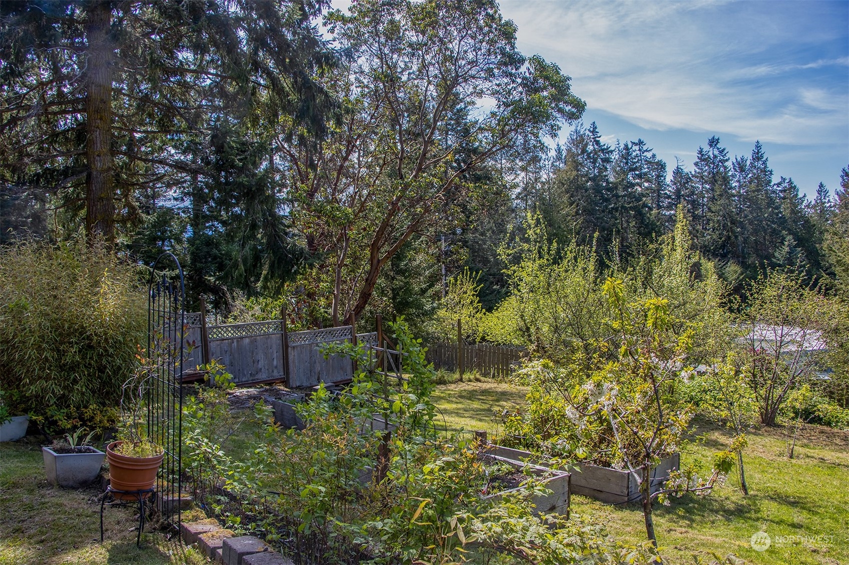 5291 Cape George Road Port Townsend, WA 98368 - Photo 5 of 25 a view of a garden with a bench