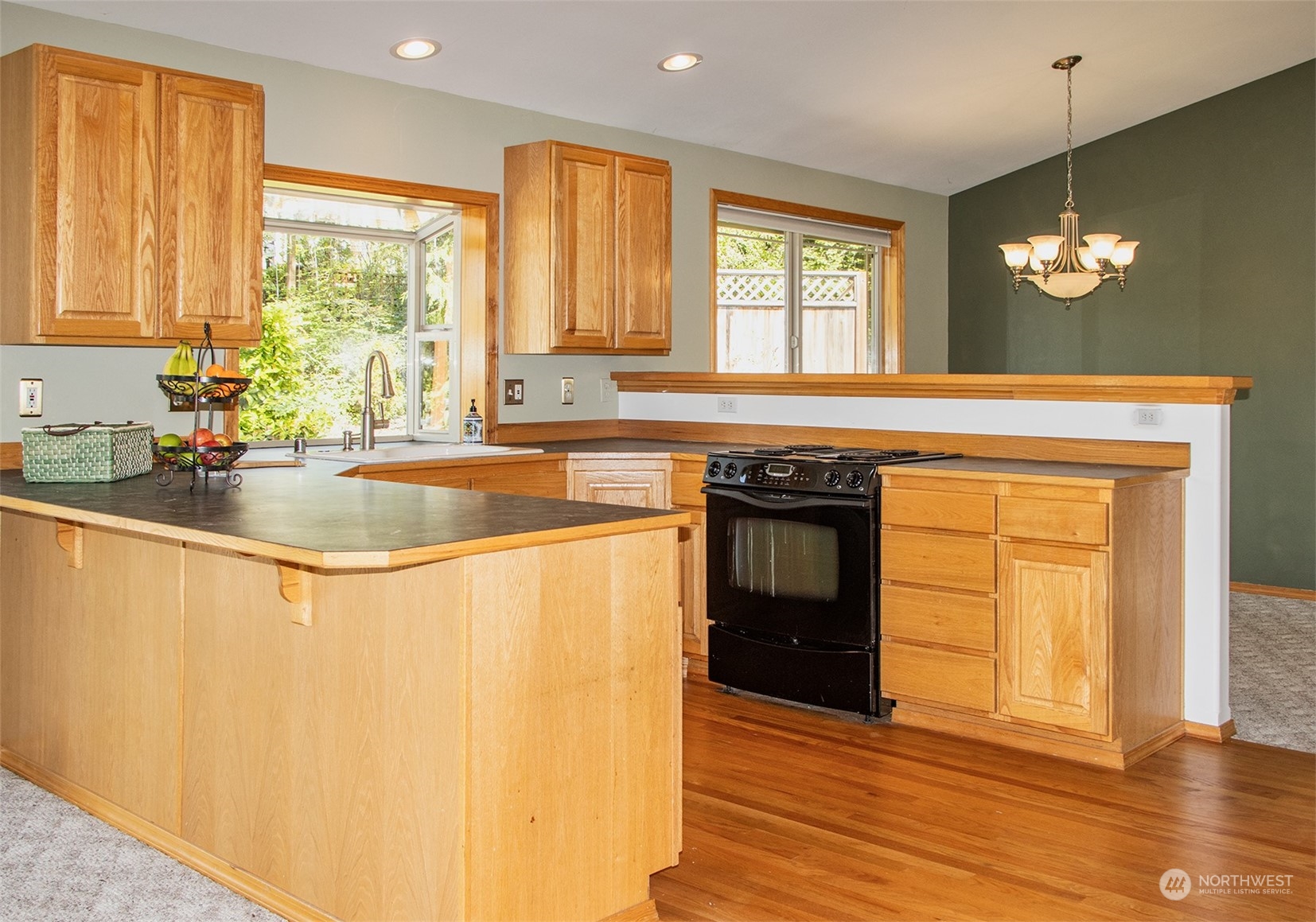 5291 Cape George Road Port Townsend, WA 98368 - Photo 10 of 25 a kitchen with stainless steel appliances granite countertop a stove a sink and a microwave