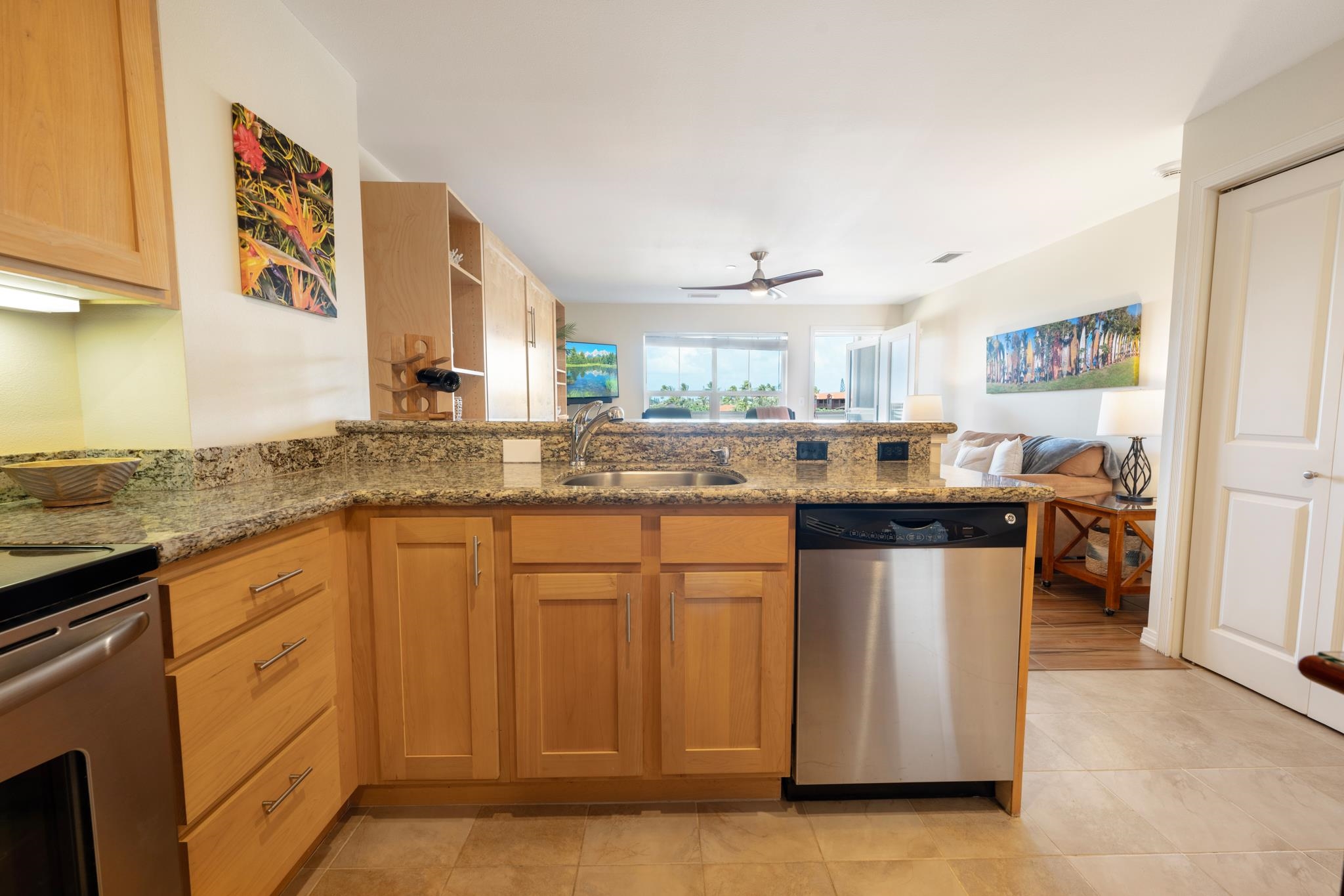 3708 Lower Honoapiilani Road, Unit E41 Lahaina, HI 96761 - Photo 20 of 42 a kitchen with stainless steel appliances granite countertop a sink and cabinets