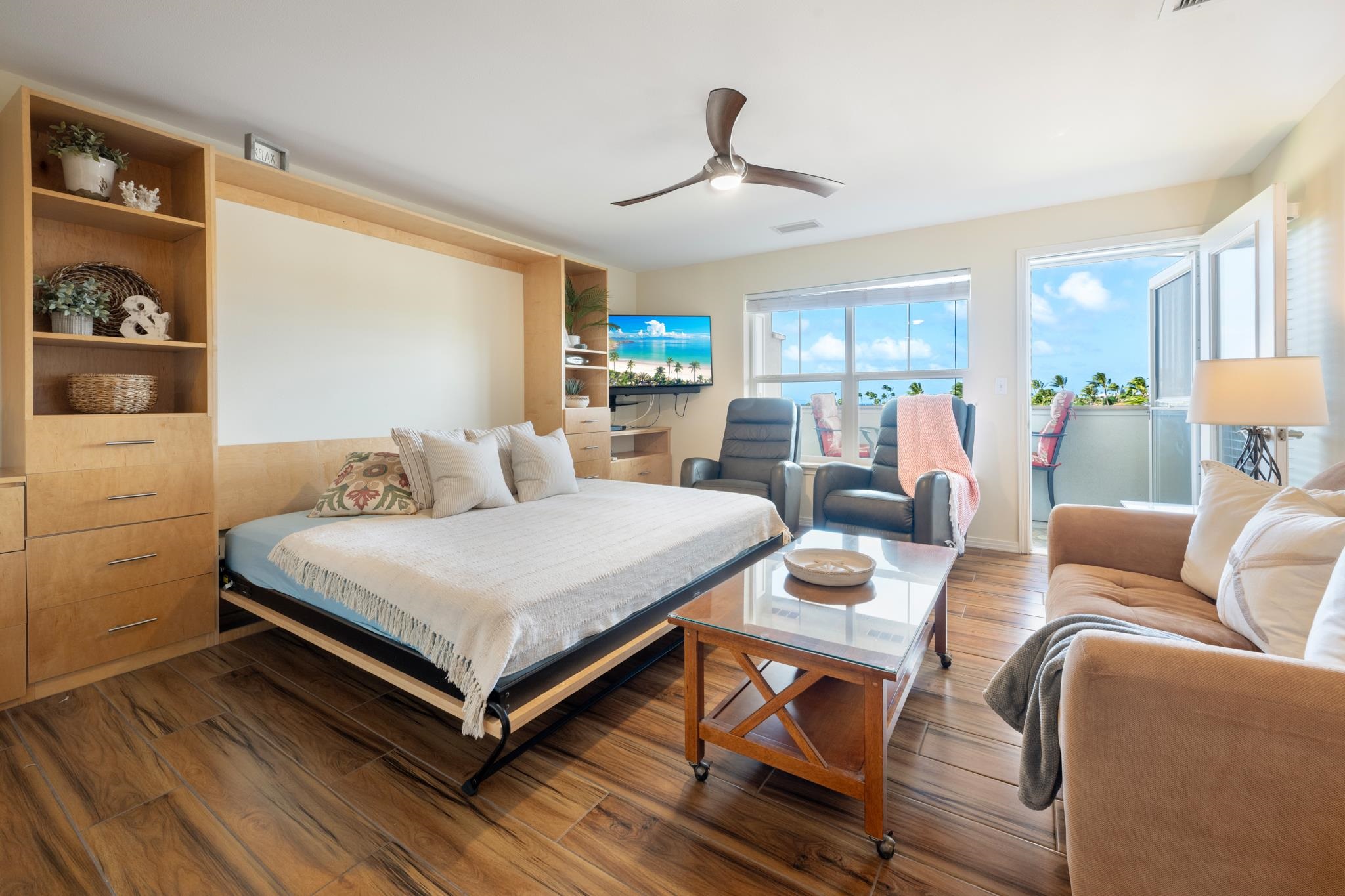 3708 Lower Honoapiilani Road, Unit E41 Lahaina, HI 96761 - Photo 6 of 42 a living room with furniture a chandelier and a flat screen tv