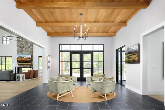 a view of a a dining room with furniture window and wooden floor