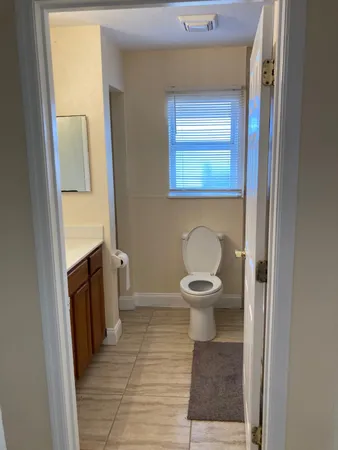 a white toilet sitting next to a bathroom sink